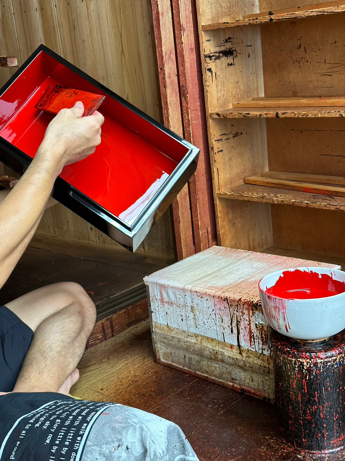Artisan hand-applying urushi lacquer in Echizen workshop